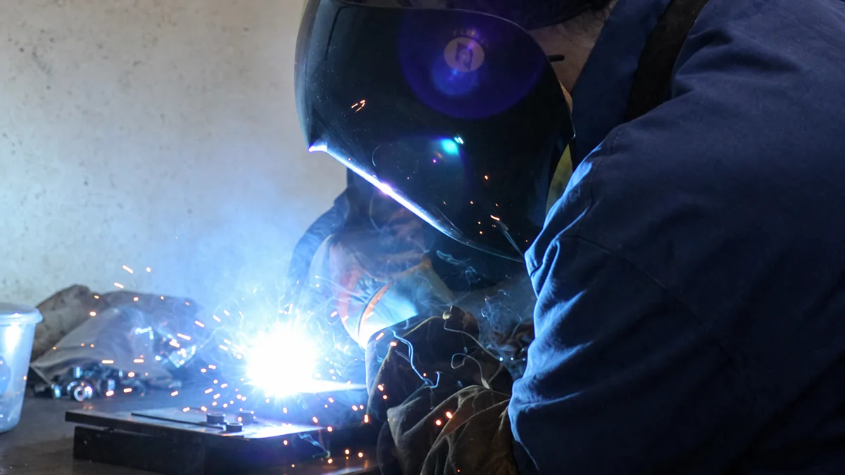 A Traker fabricator welding a component in the workshop